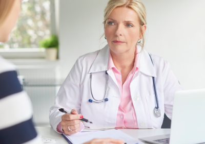 woman discussing pelvic floor muscle dysfunction with doctor