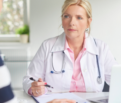 woman discussing pelvic floor muscle dysfunction with doctor