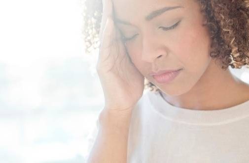 Young woman experiencing brain fog and headaches