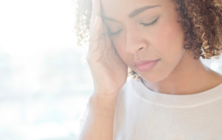 Young woman experiencing brain fog and headaches