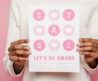 uterine fibroids breast cancer holding pink sign about awareness