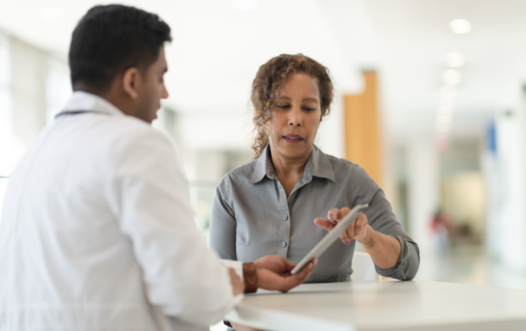 Woman meeting with doctor discussing fibroid pain.